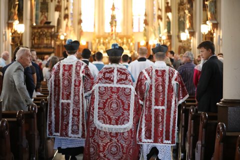 St. Joseph Shrine: Clergy in red vestments processing down the Gothic nave during a Solemn High Mass
