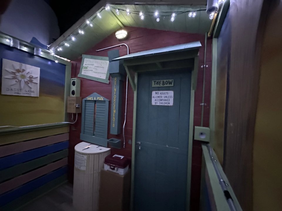 Colorful clubhouse set with string lights, a blue door and a peek window
