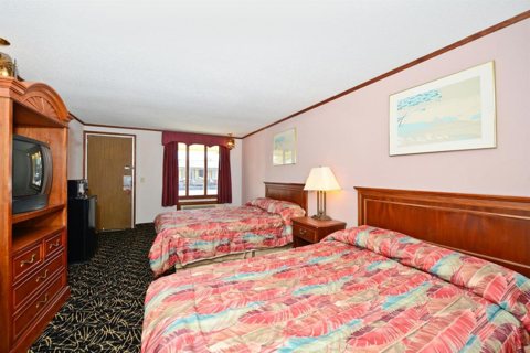 A room with two beds and a TV cabinet