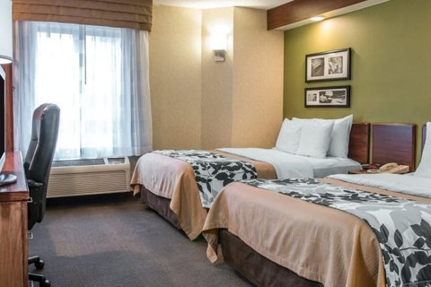 A guest room with two beds and patterned bedspreads