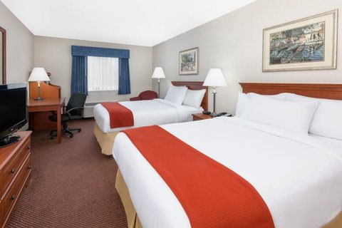 A room with two beds and a desk