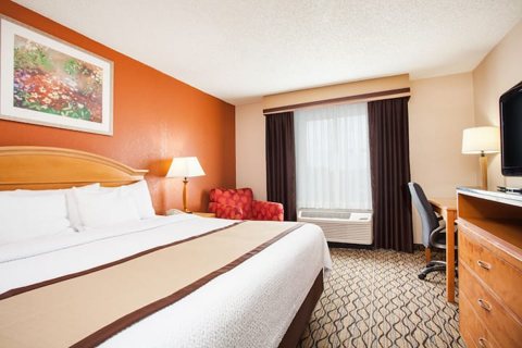 A room with a large bed and a desk