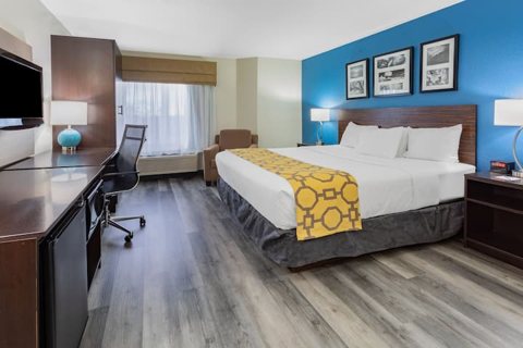 A room with a blue accent wall and a desk