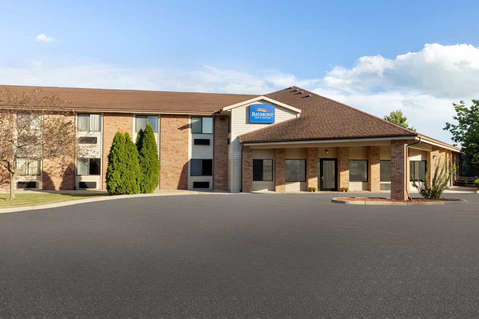 The hotel's low brown-roofed building and parking lot