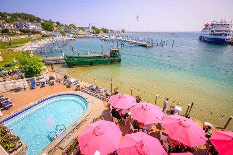The outdoor pool and the pink-umbrella patio above the harbor