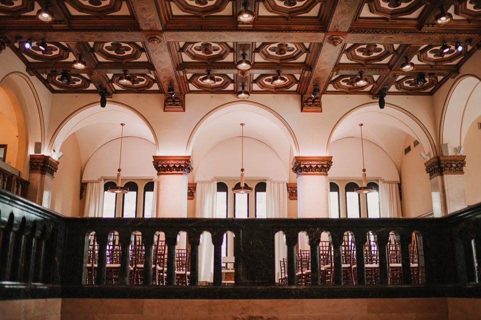 The hotel's ballroom with a coffered wooden ceiling, arches and a balcony