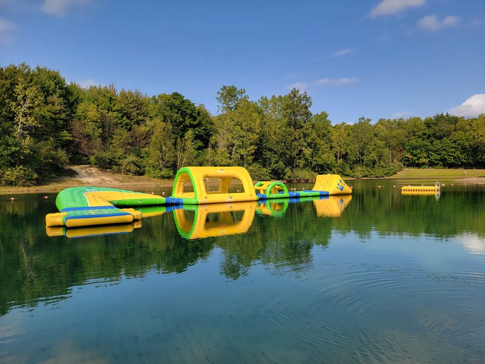 A lake with colorful water toys at the campground