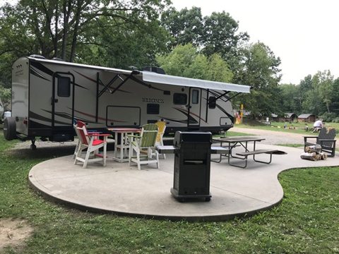 A trailer on a campsite with a table