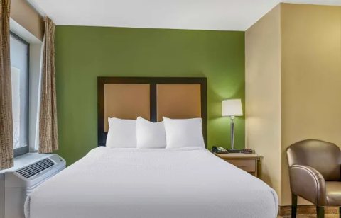 A room with a bed and an armchair