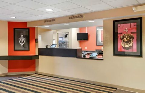 The front desk with a red wall and framed pictures
