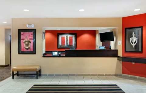 The front desk with a red wall and a striped rug
