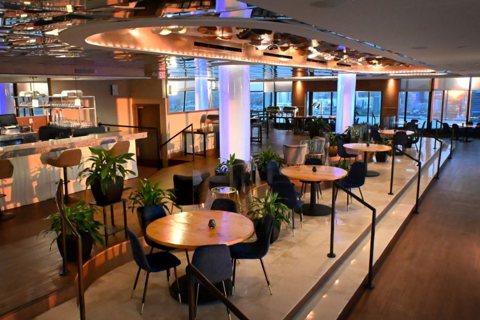 The top-floor bar and restaurant with round tables and panoramic windows
