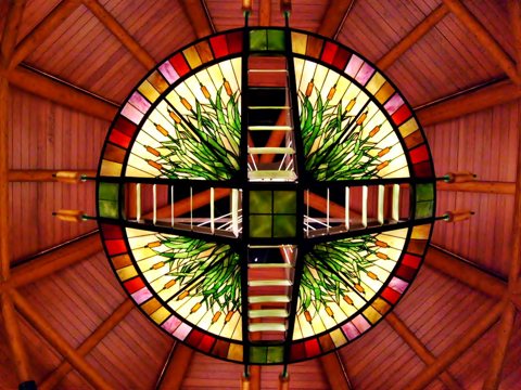 The round stained-glass ceiling with a cattail pattern above the casino entrance