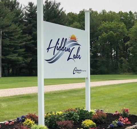 The resort entrance sign with a flower bed