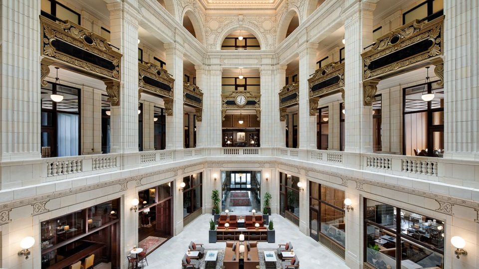 The four-storey marble atrium of the David Whitney Building with the lobby below