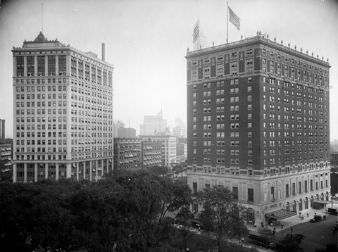A black-and-white photo of the Whitney Building and the Statler Hotel from the 1910s or 1920s