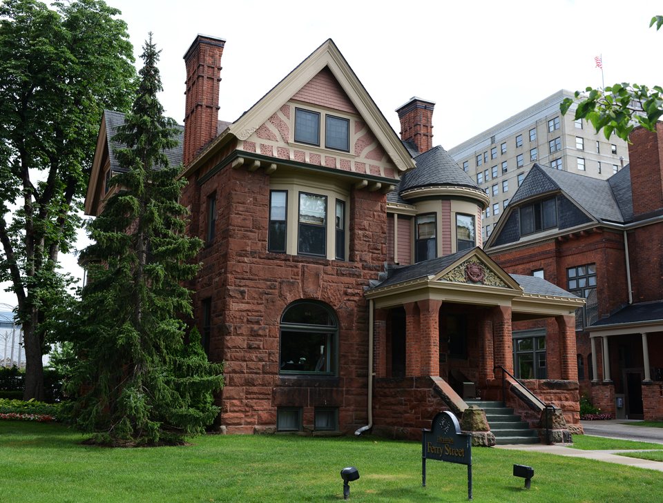 The Inn on Ferry Street's red stone and brick Victorian house with its sign