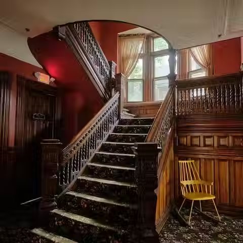 A carved wooden staircase inside one of the inn's historic houses