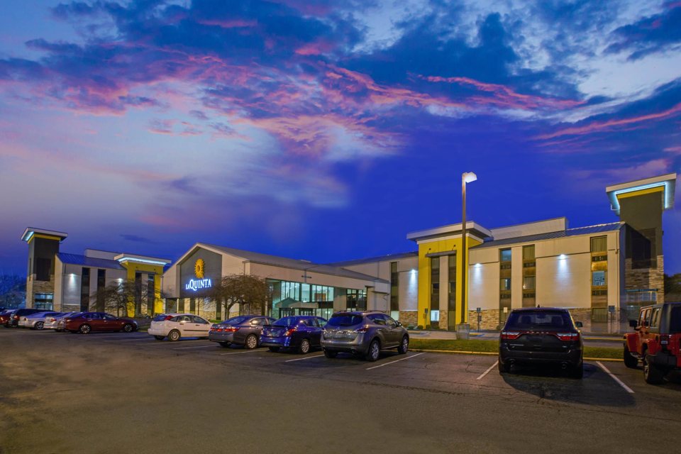 The La Quinta hotel building and its lit sign at dusk
