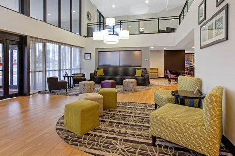 The lobby with yellow armchairs and a gallery level