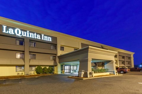 The hotel building and its lit sign at night