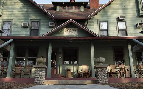 The inn's porch with rocking chairs under the Lakeside Inn gable sign