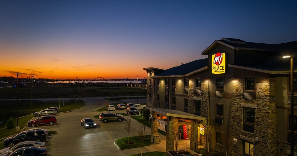 The hotel building lit at dusk with its sign