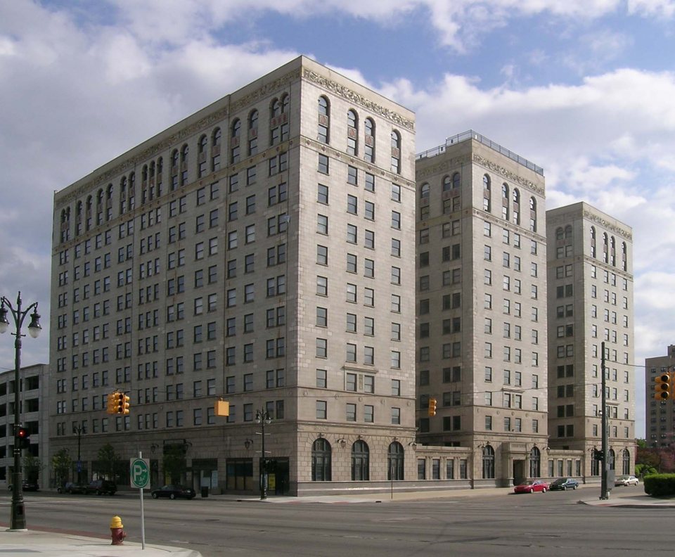 The Park Shelton's twelve-story pale stone building under a partly cloudy sky in 2008