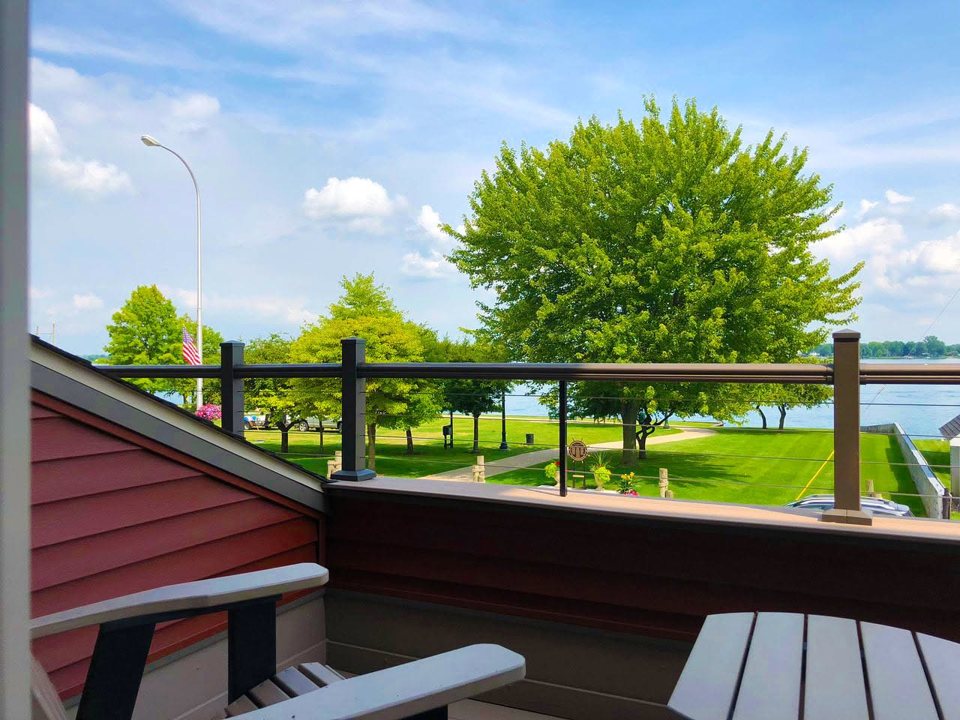 View from a hotel balcony over the green riverside park and the St. Clair River