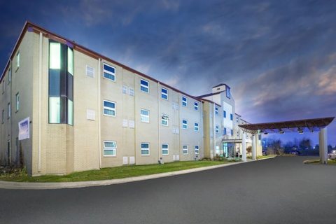 The hotel building and entrance canopy at dusk