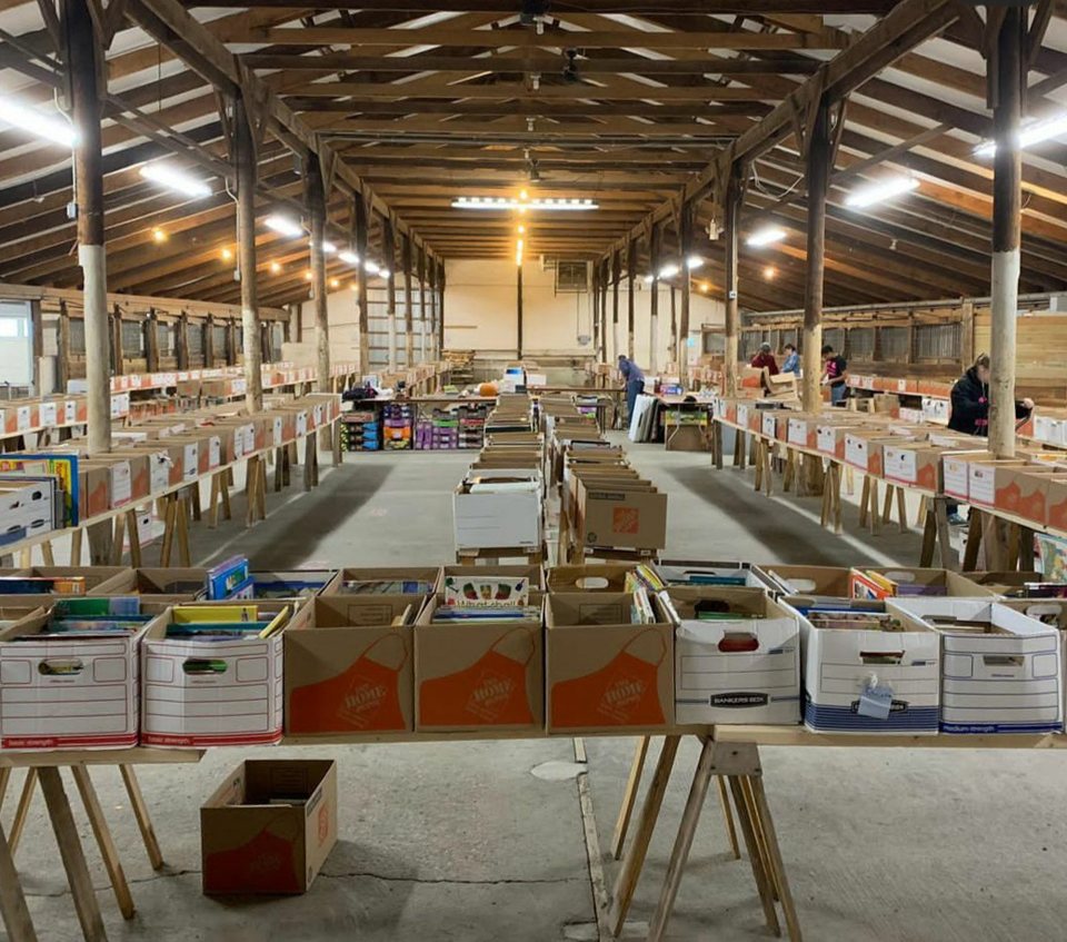 Inside the fairgrounds exhibit hall with tables