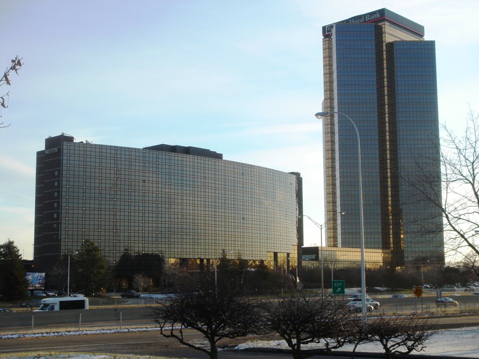 The hotel's curved bronze-glass building with a Town Center office tower behind it