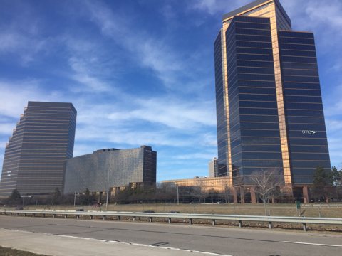 The Southfield Town Center towers with the lower hotel building between them under a blue sky