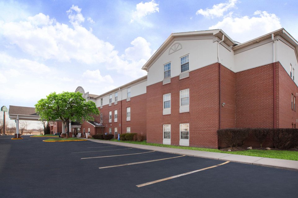 The hotel's brick facade and parking lot