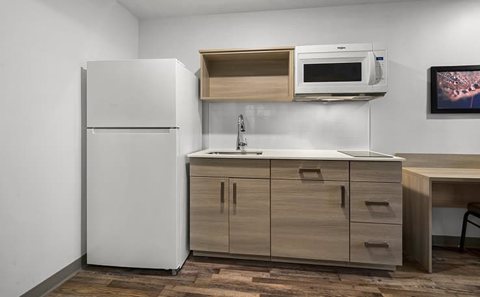 The room's kitchenette with a refrigerator, sink and microwave