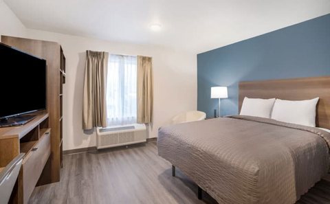 Guest room with a bed and blue wall