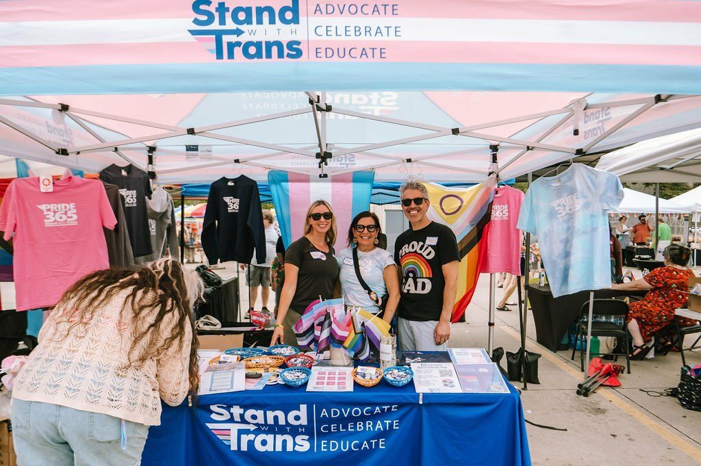 Stand with Trans booth with T-shirts and flags at Berkley Pride