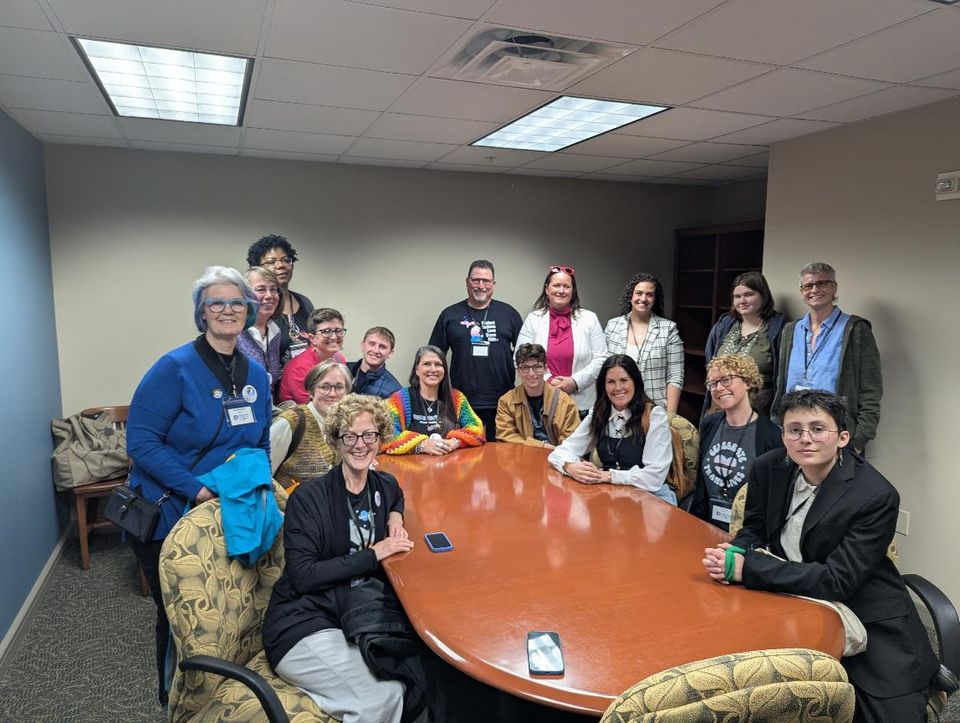 Group photo of community members around a conference table