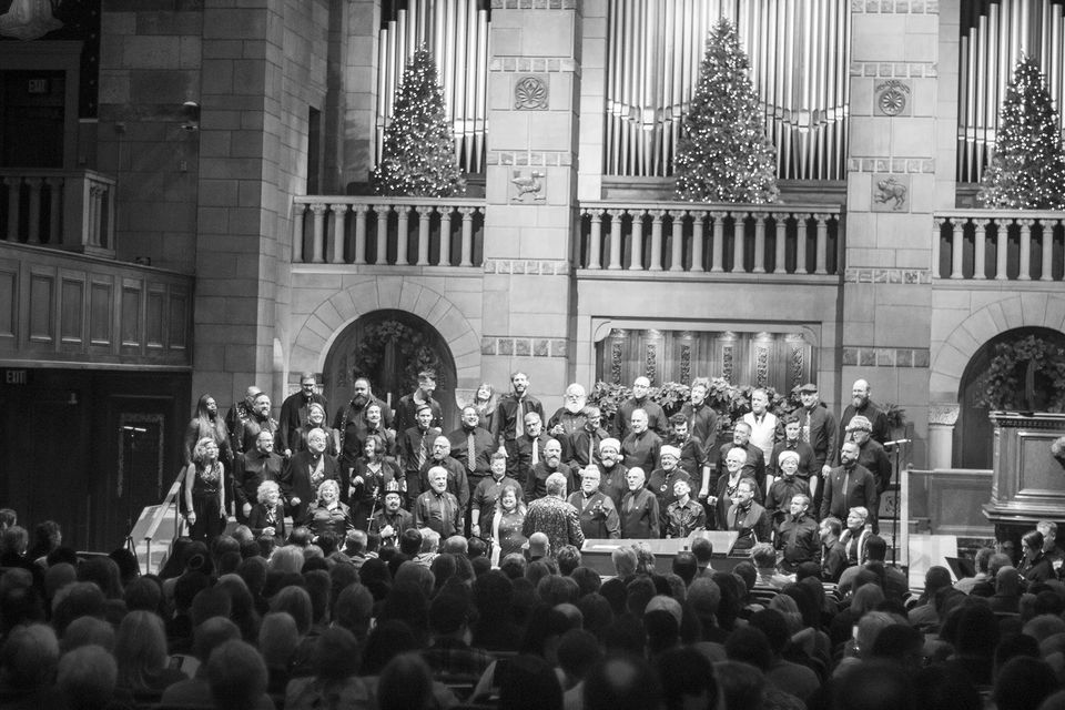 Black-and-white photo of the chorus singing before an audience in an ornate church