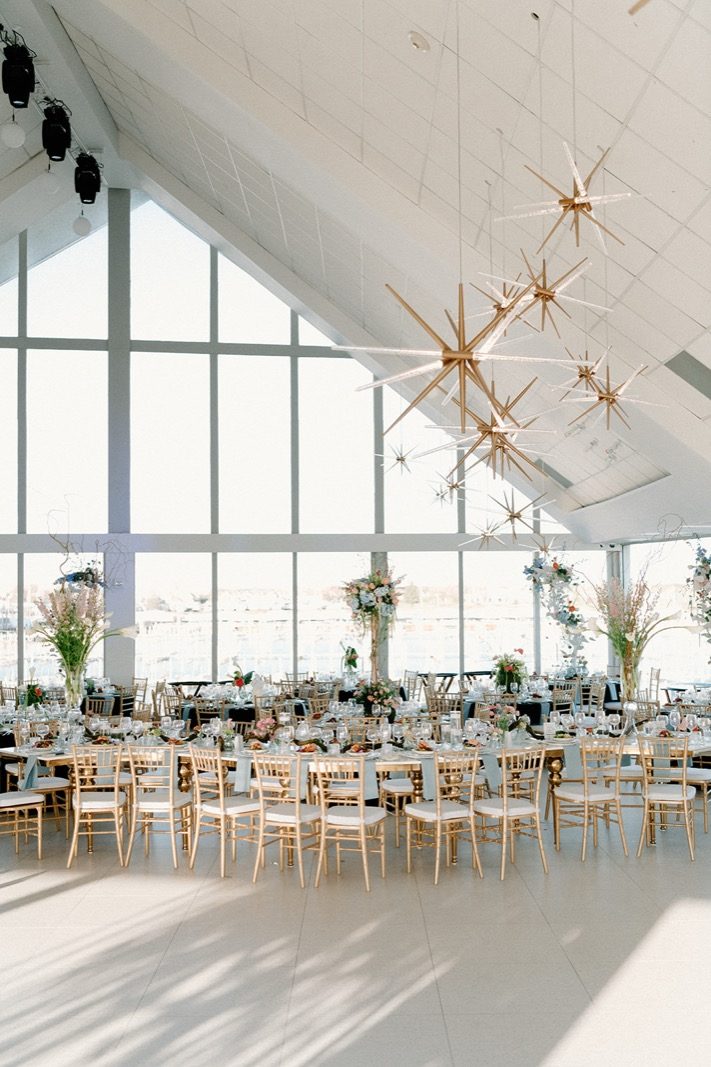 The Roostertail — Palm River Room set for a seated dinner, river-facing glass wall