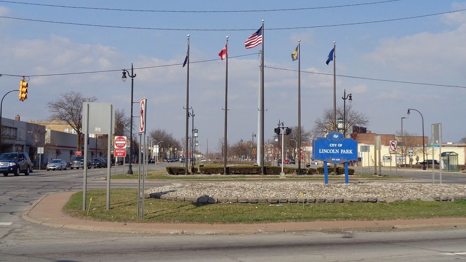 Flags and the city sign at Southfield Road and Fort Street