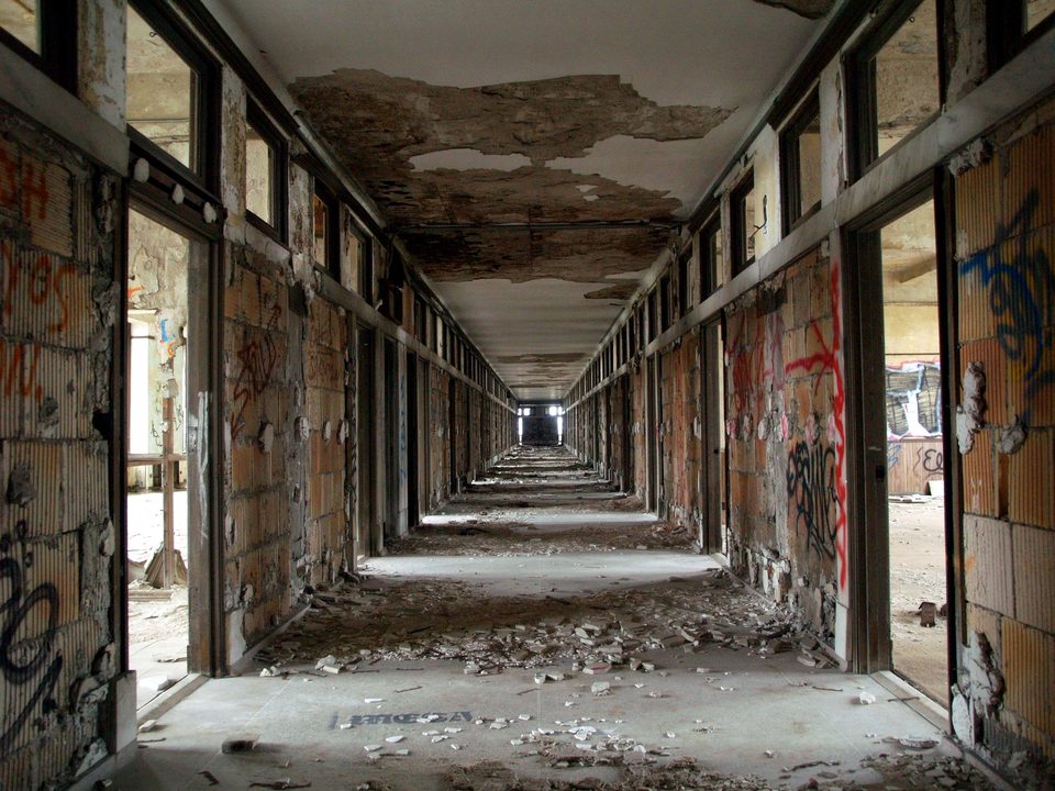 An office hallway with collapsing ceilings and graffiti, 2010
