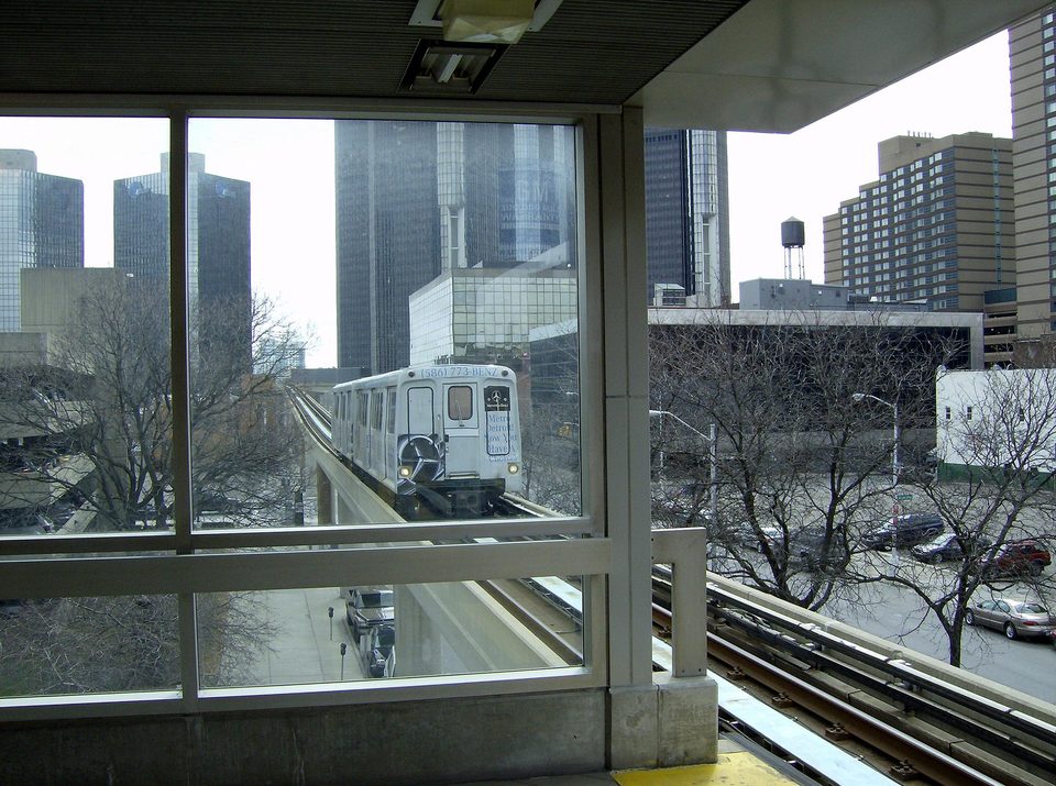 A train entering Bricktown station, with the Renaissance Center behind