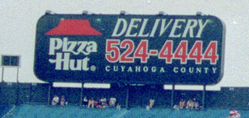A Pizza Hut Delivery billboard with the classic logo at a Detroit Tigers game in Cleveland, 1991