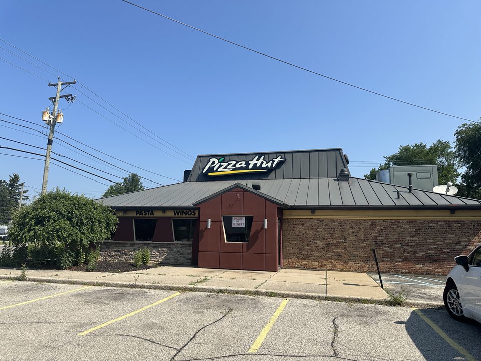 A closed old Pizza Hut with the pointed roof and five-sided windows, Elkhart, Indiana