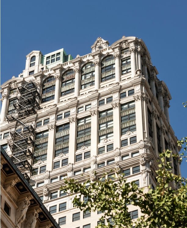 The ornate Book Tower facade from below against a blue sky