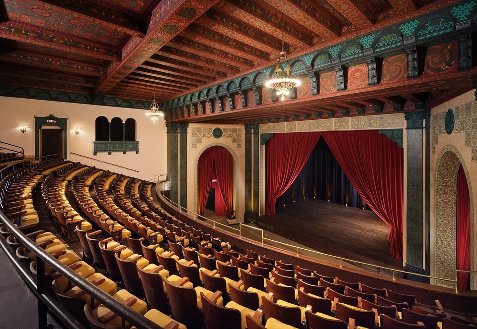 The house from the balcony: painted beamed ceiling and red curtain