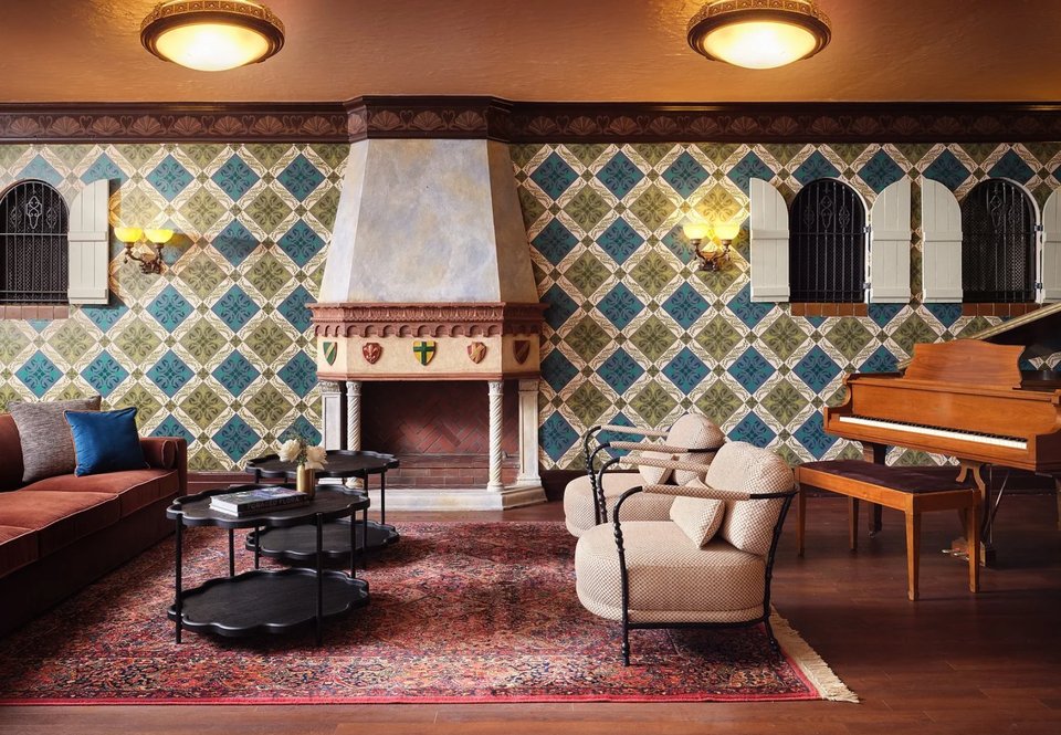 The Jessie Bonstelle Lounge with a tiled fireplace, piano and armchairs