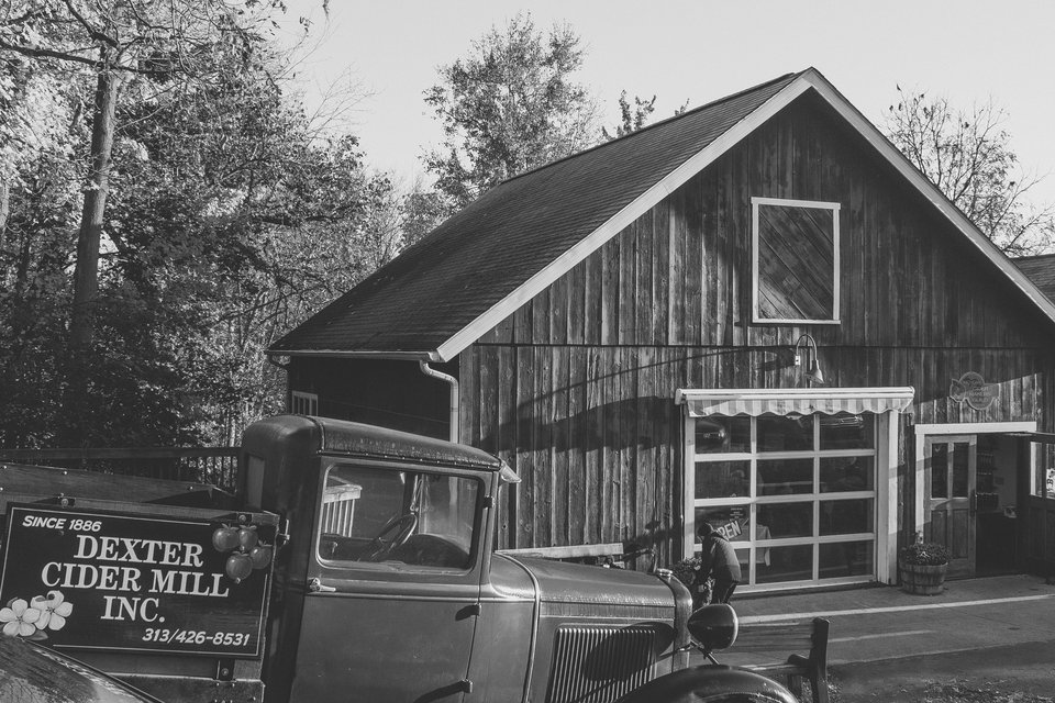 Black-and-white shot of the mill with a vintage Dexter Cider Mill truck in front