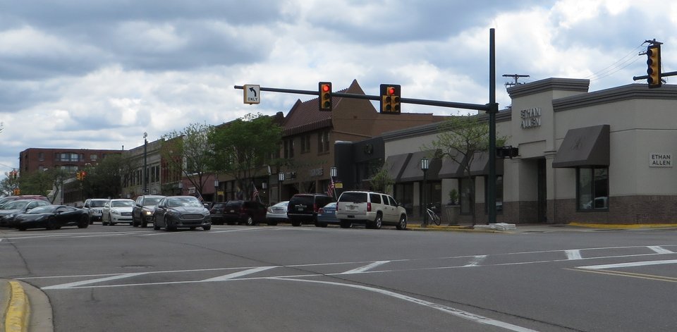 A crossing on Old Woodward Avenue with a low row of shops